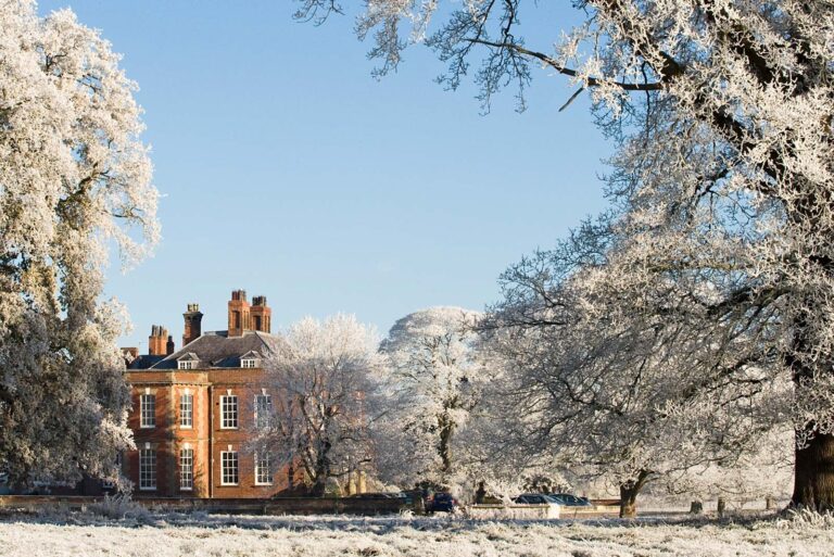 The house across the parkland after snow, tall trees frosted white, Iscoyd Park