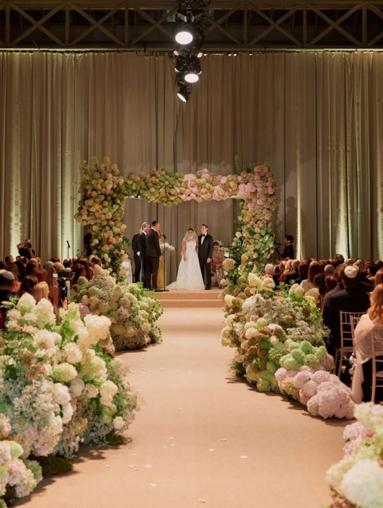 A ceremony under a chuppah of cream and blush hydrangeas in a grand London venue, Italian Eye