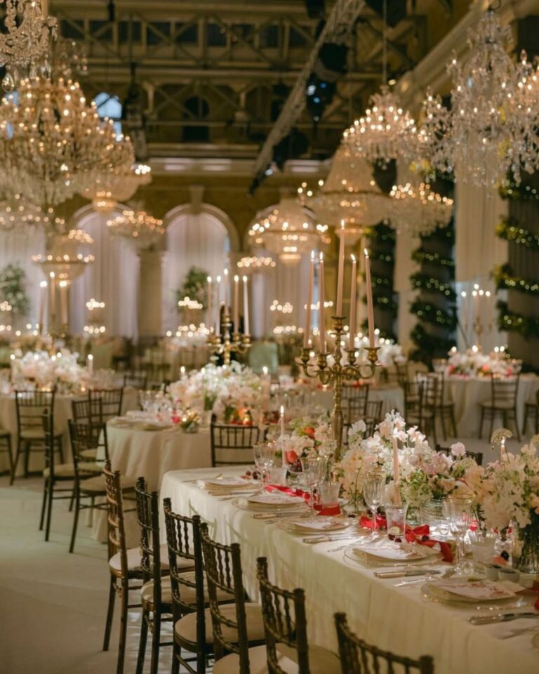 Candlelit ballroom tables with pink and white blooms beneath chandeliers, Italian Eye