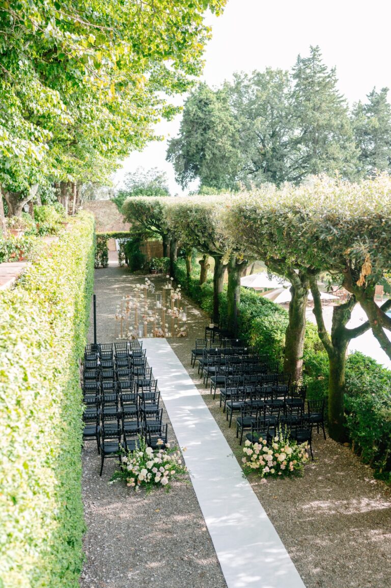 Ceremony chairs along a pale aisle between clipped hedges, Italian Wedding