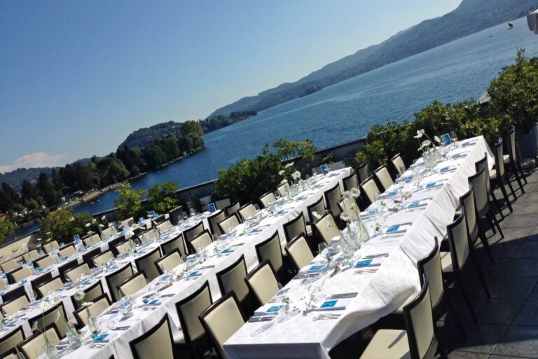 Long tables laid down a terrace above Lake Orta at Hotel Giardinetto, the far shore and hills beyond, Italian Wedding Company