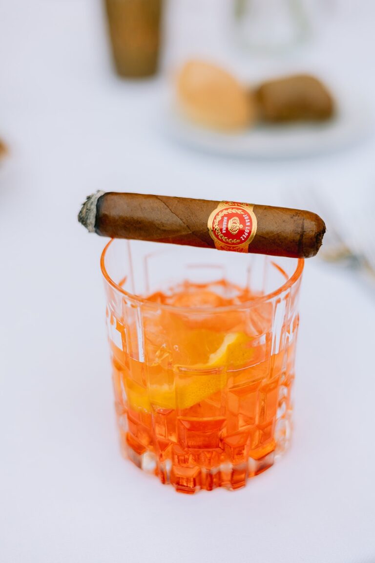 Orange spritz-style cocktail and cigar on the table, Italian Wedding