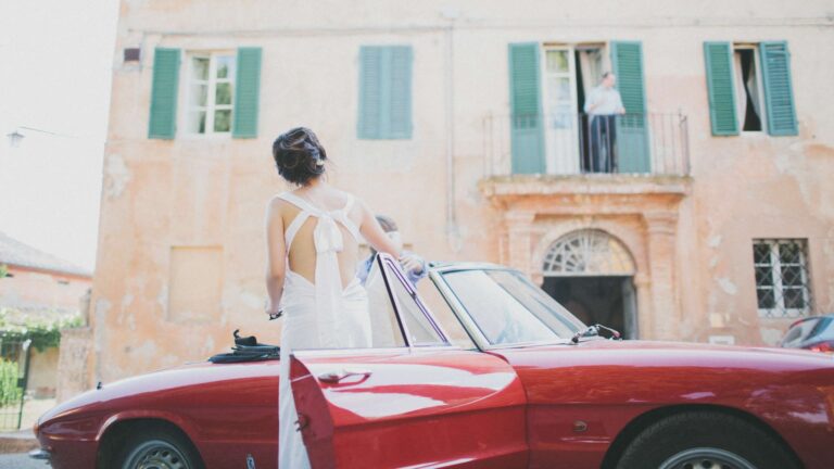 Bride beside a vintage red convertible outside a Tuscan villa, Italian Wedding