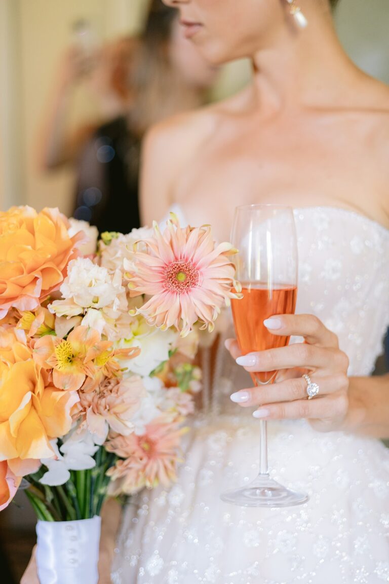 Bride with a peach and apricot bouquet and a drink, Italian Wedding
