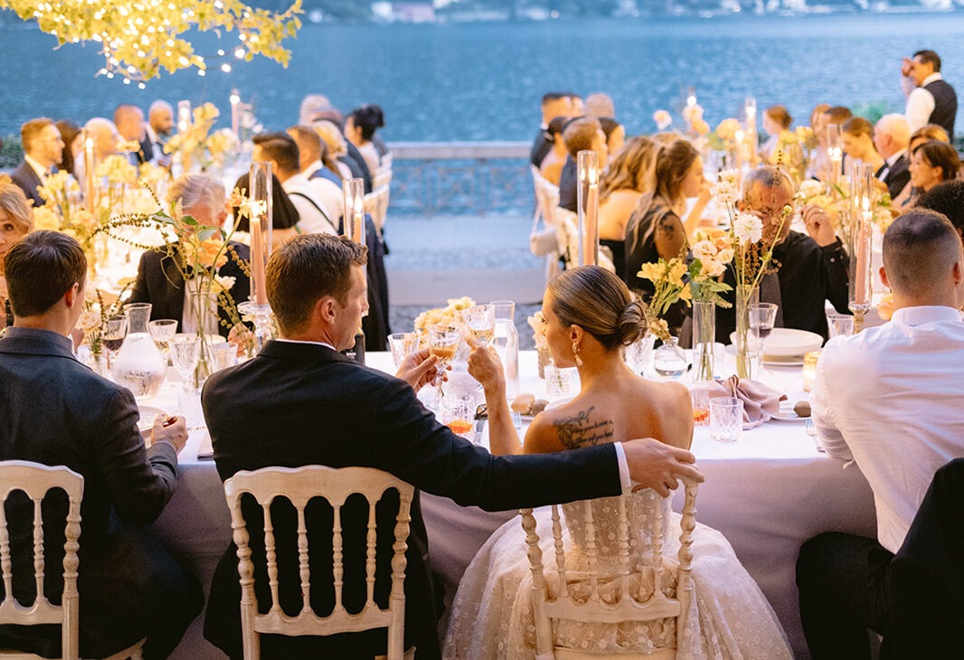 Reception guests at a long table overlooking the lake, Italian Wedding