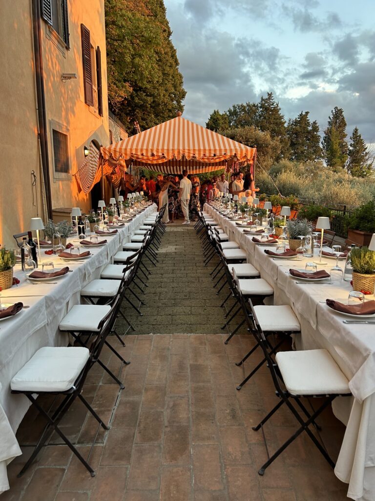 Long reception tables beneath a striped canopy, Lake Como, Italian Wedding