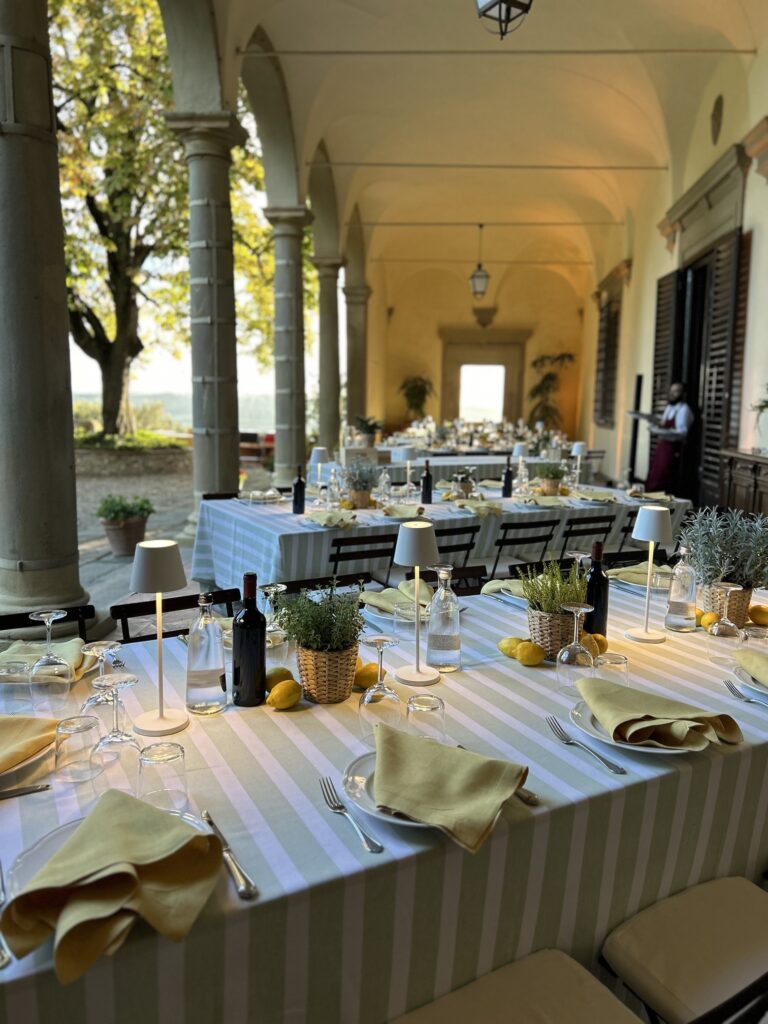 Banquet tables set along a colonnaded loggia, Italian Wedding