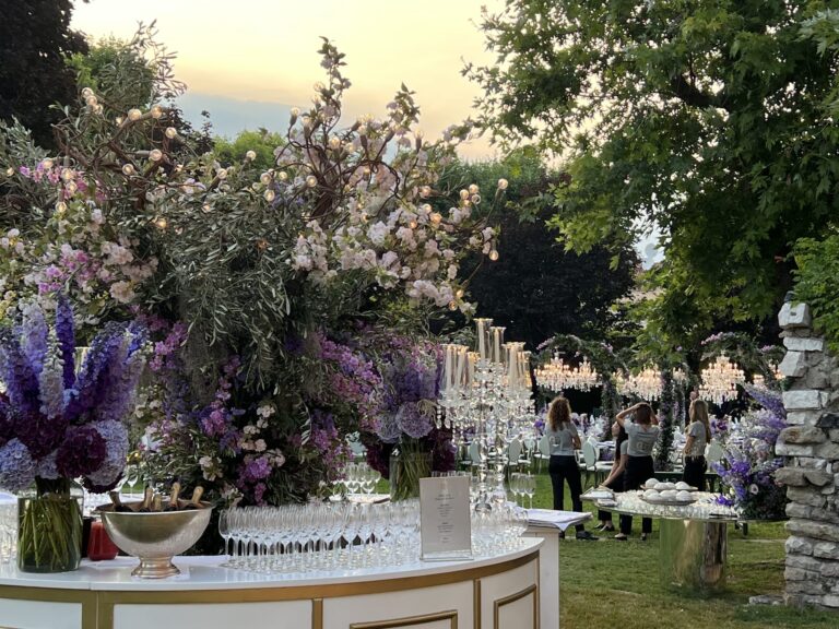 Guests gather at dusk beneath the garden's hanging chandeliers, Jamie Aston