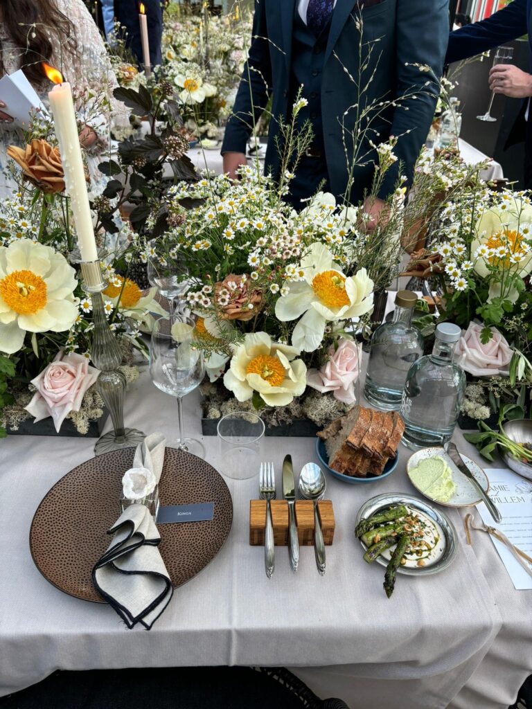 A place setting dressed with daffodil, narcissus and candlelight, glasshouse reception, Jamie Aston
