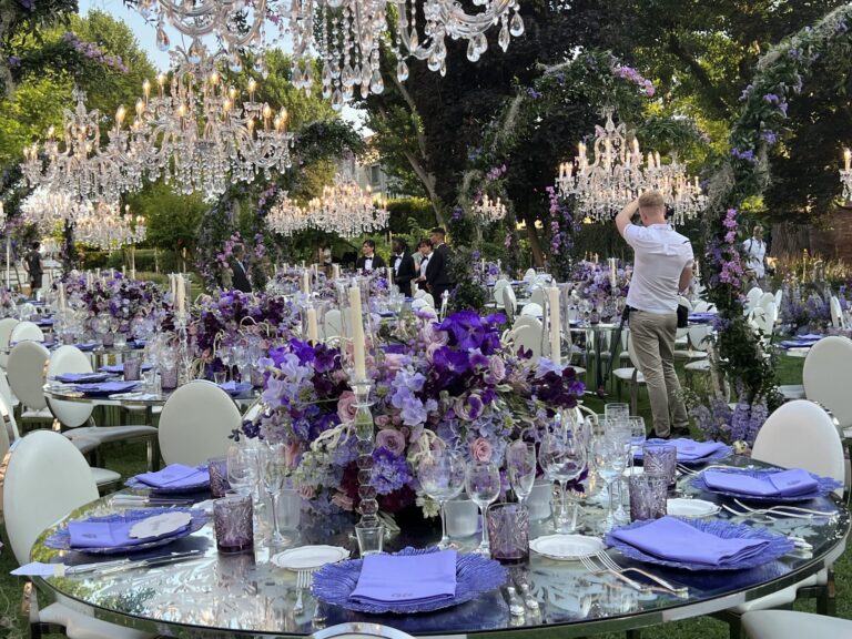 Crystal chandeliers hang from the trees above a lavender-dressed garden reception, Jamie Aston