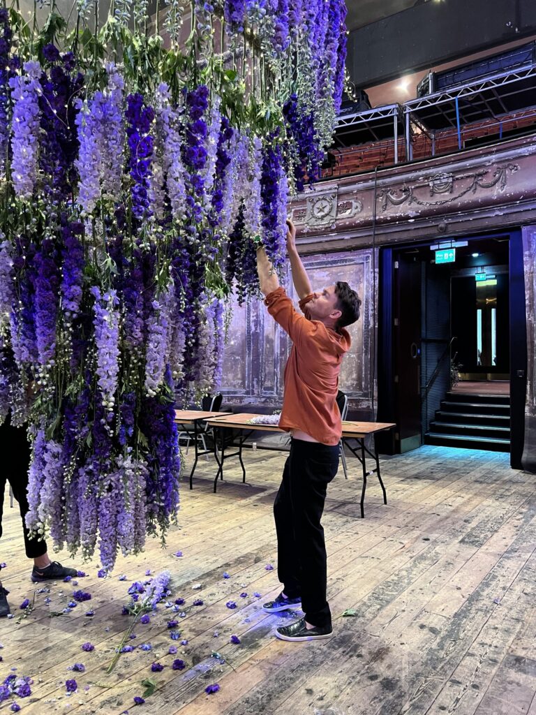 The delphinium installation takes shape, cascading from the ceiling, Jamie Aston