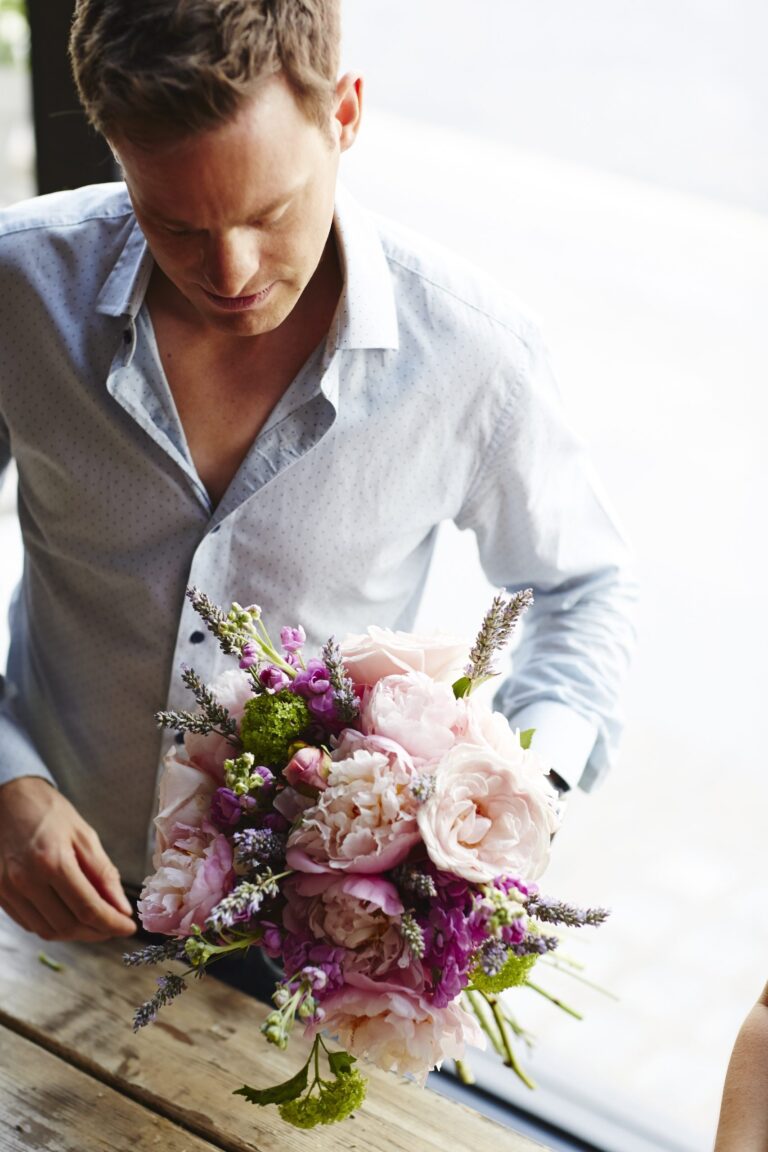 Jamie Aston, founder, arranging a bouquet in the studio. Photograph by Matt Russell, Jamie Aston