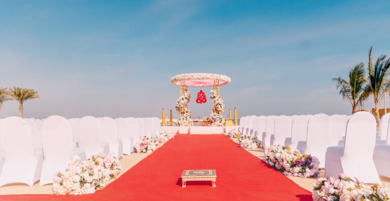 Red carpet aisle and mandap for a beach ceremony at Soul Beach, Jebel Ali Golf Resort