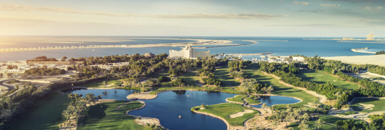 The JA Golf Course and the resort beside the sea from above, Jebel Ali Golf Resort