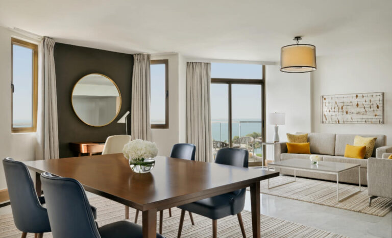 The living and dining area of a Premium One Bedroom Suite at JA Beach Hotel, Jebel Ali Golf Resort