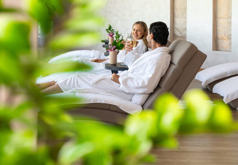 Guests relaxing in robes on spa loungers, Jebel Ali Golf Resort