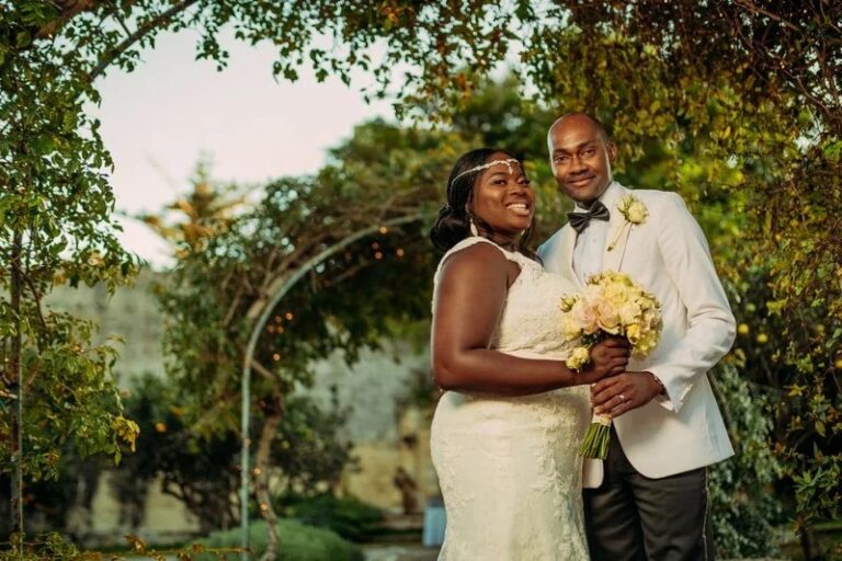 The couple beside a rose arbour in the gardens, Jewelweddings Event Planners