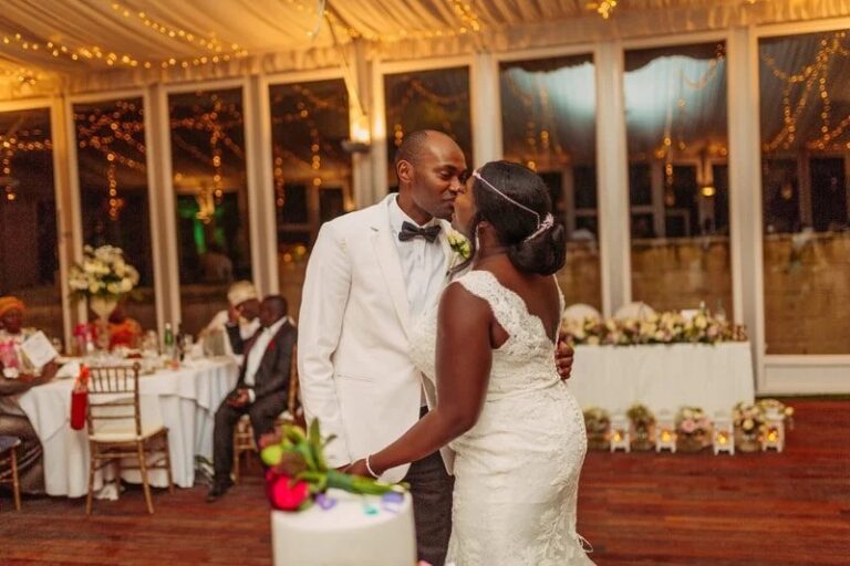 The couple dance under fairy lights in a glass-walled reception room, Jewelweddings Event Planners