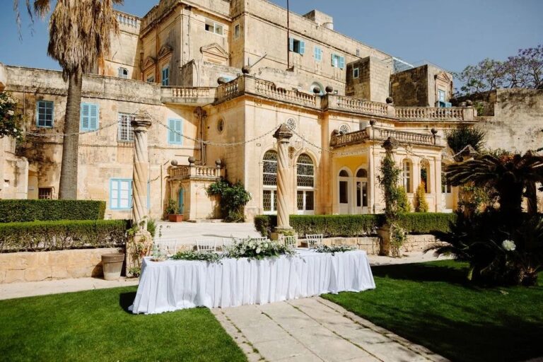 Top table set on the lawn before a limestone villa, Jewelweddings Event Planners