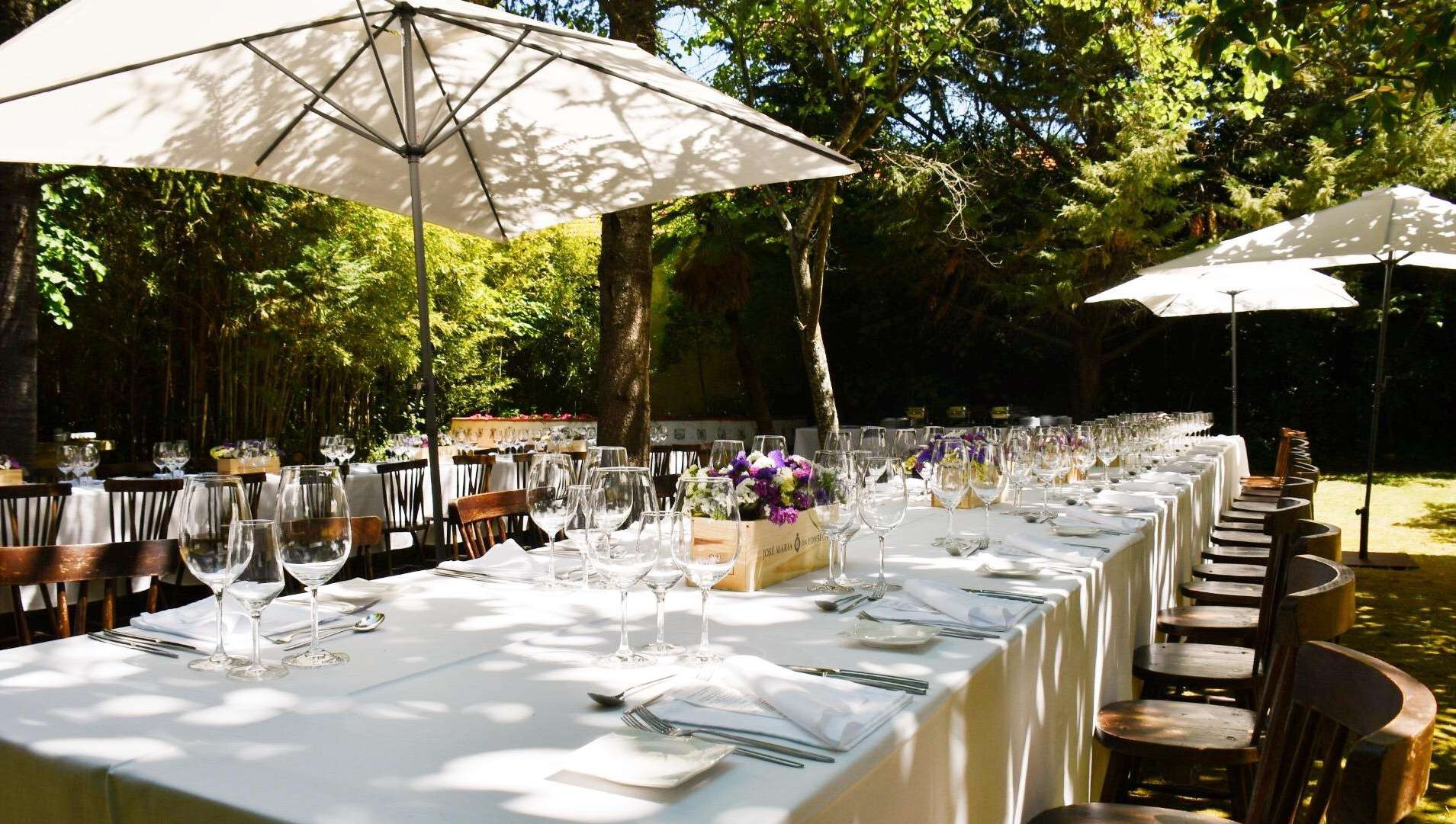 Tables and parasols laid for a garden lunch, José Maria da Fonseca Casa Museu