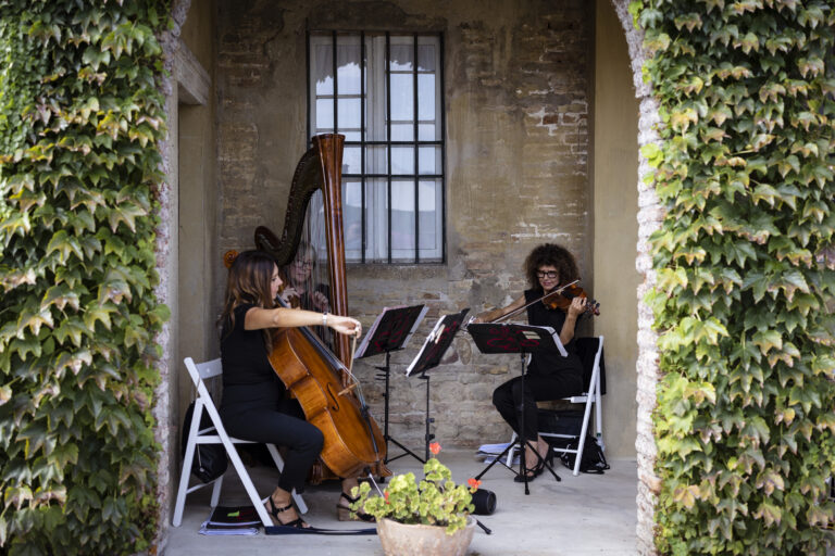 Harp and cello playing under an ivy-covered loggia at Villa Cattani Stuart, Pesaro, Joy Wedding