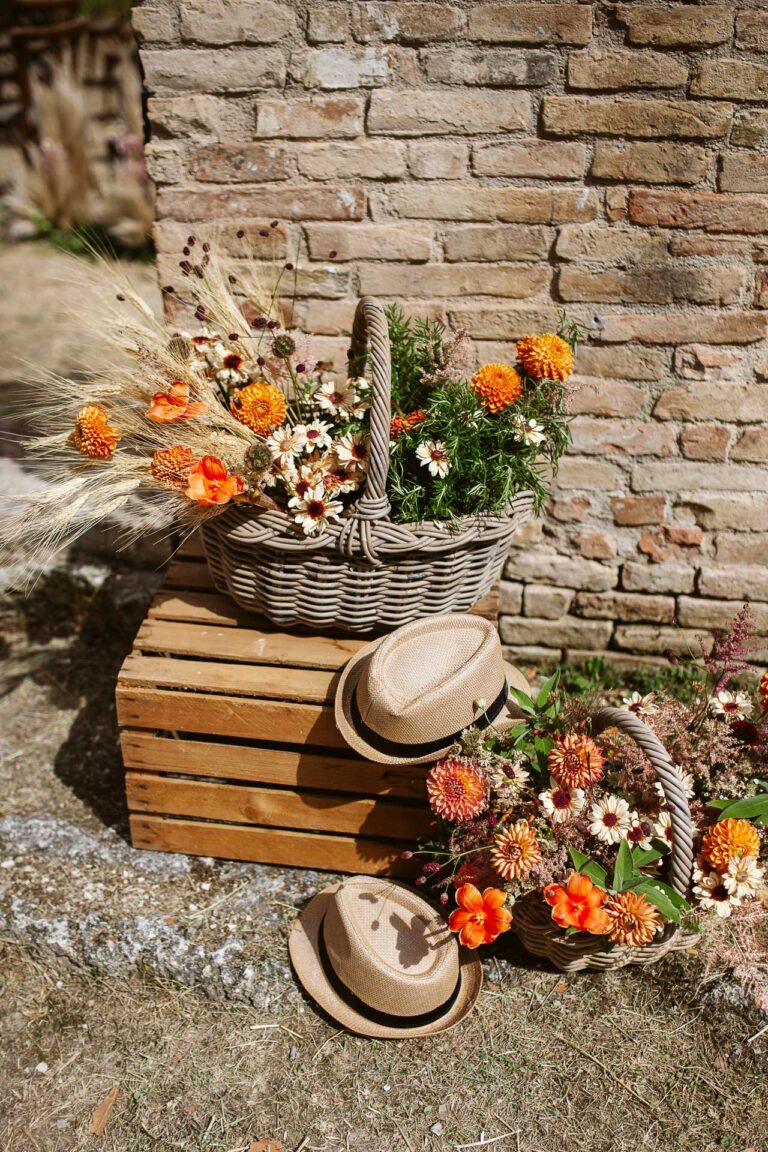Baskets of dried and orange flowers with straw hats on wooden crates, Barco Ducale, Urbania, Joy Wedding
