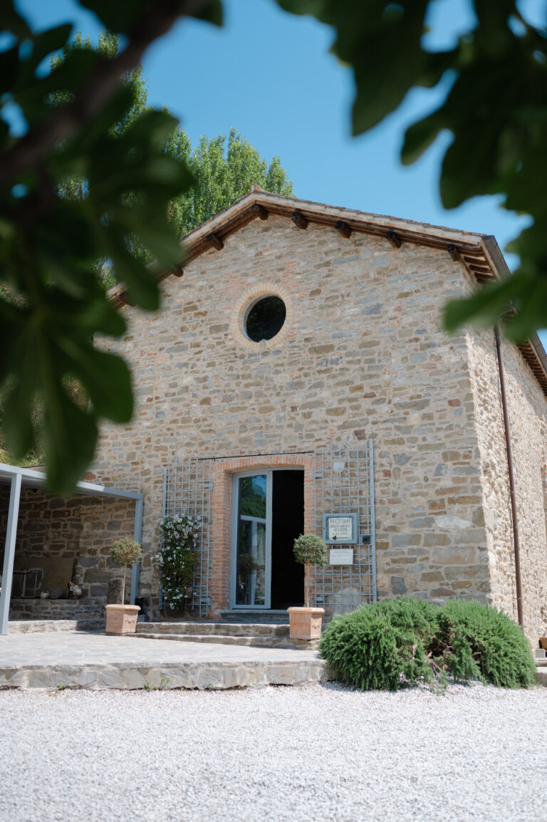 The stone chapel at Nikis Resort, Umbria, framed by fig leaves, Joy Wedding