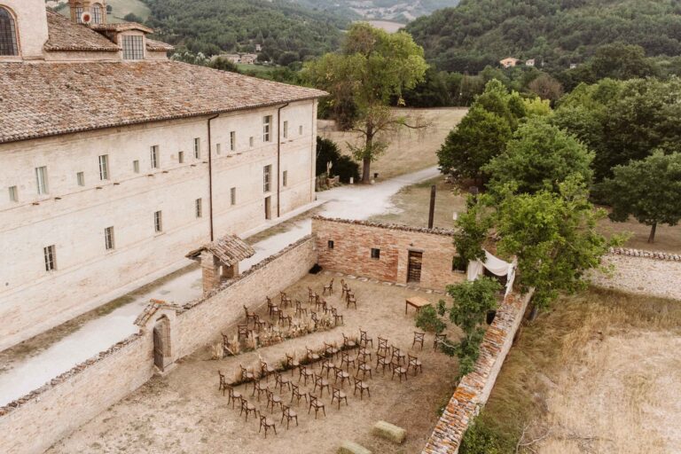 Aerial view of the Barco Ducale, Urbania, with the ceremony set in the walled courtyard, Joy Wedding
