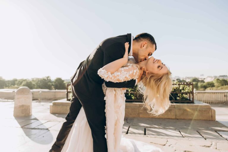 A couple embrace on a terrace at a destination wedding, Julia Event