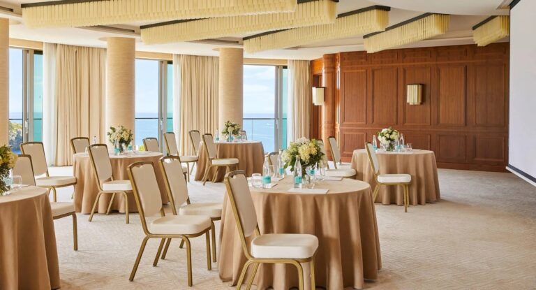 The Jumeirah Ballroom, round tables set for a wedding banquet beneath tall windows to the sea, Jumeirah Port Soller Hotel & Spa