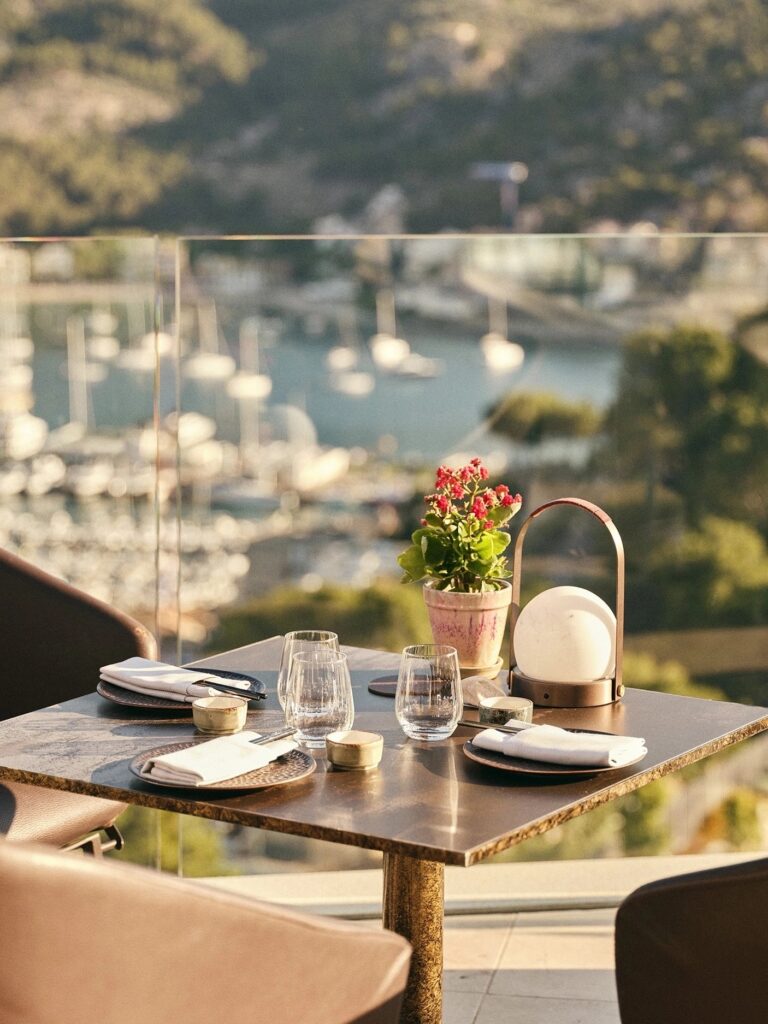 A table set for two above the marina at golden hour, Jumeirah Port Soller Hotel & Spa