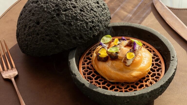 Warm bread and a signature dish served on lava stone, Jumeirah Port Soller Hotel & Spa