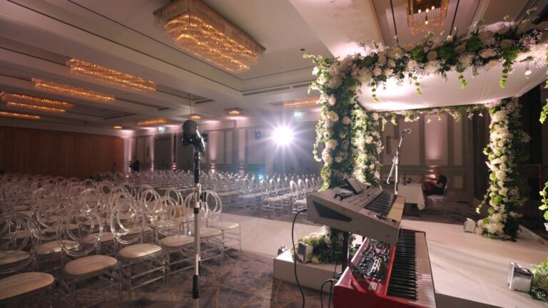 Chuppah with trailing greenery and piano, ceremony seating in rows, Just Smile Ltd