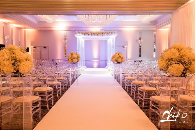 Uplit chuppah and white aisle with yellow flower arrangements, Just Smile Ltd