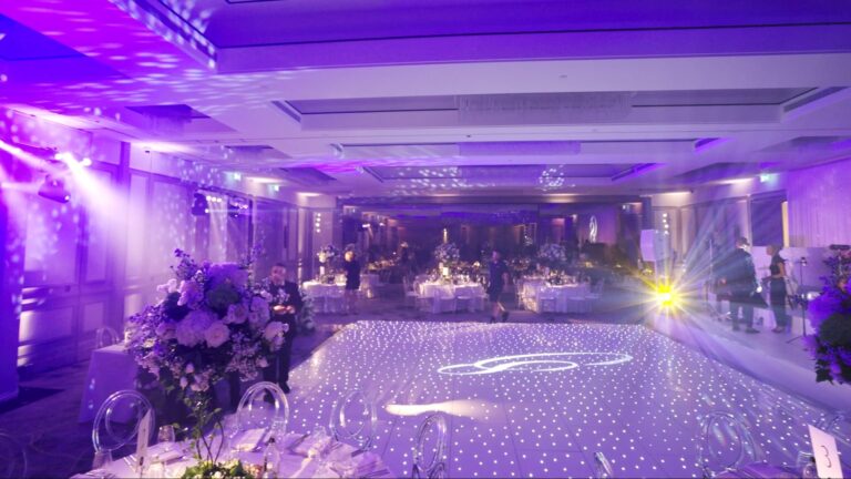Dance floor with a monogram gobo projection and floral arrangements, Just Smile Ltd