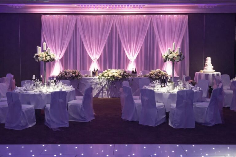 Pleated drape backdrop with a starlit dance floor and dressed tables, Just Smile Ltd