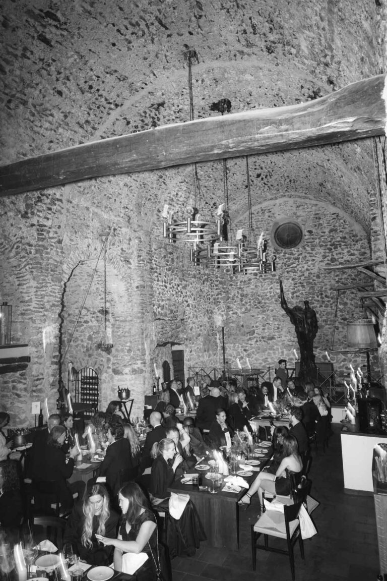 Under the stone arches, the tables laid, in black and white, Kaleidos Wedding
