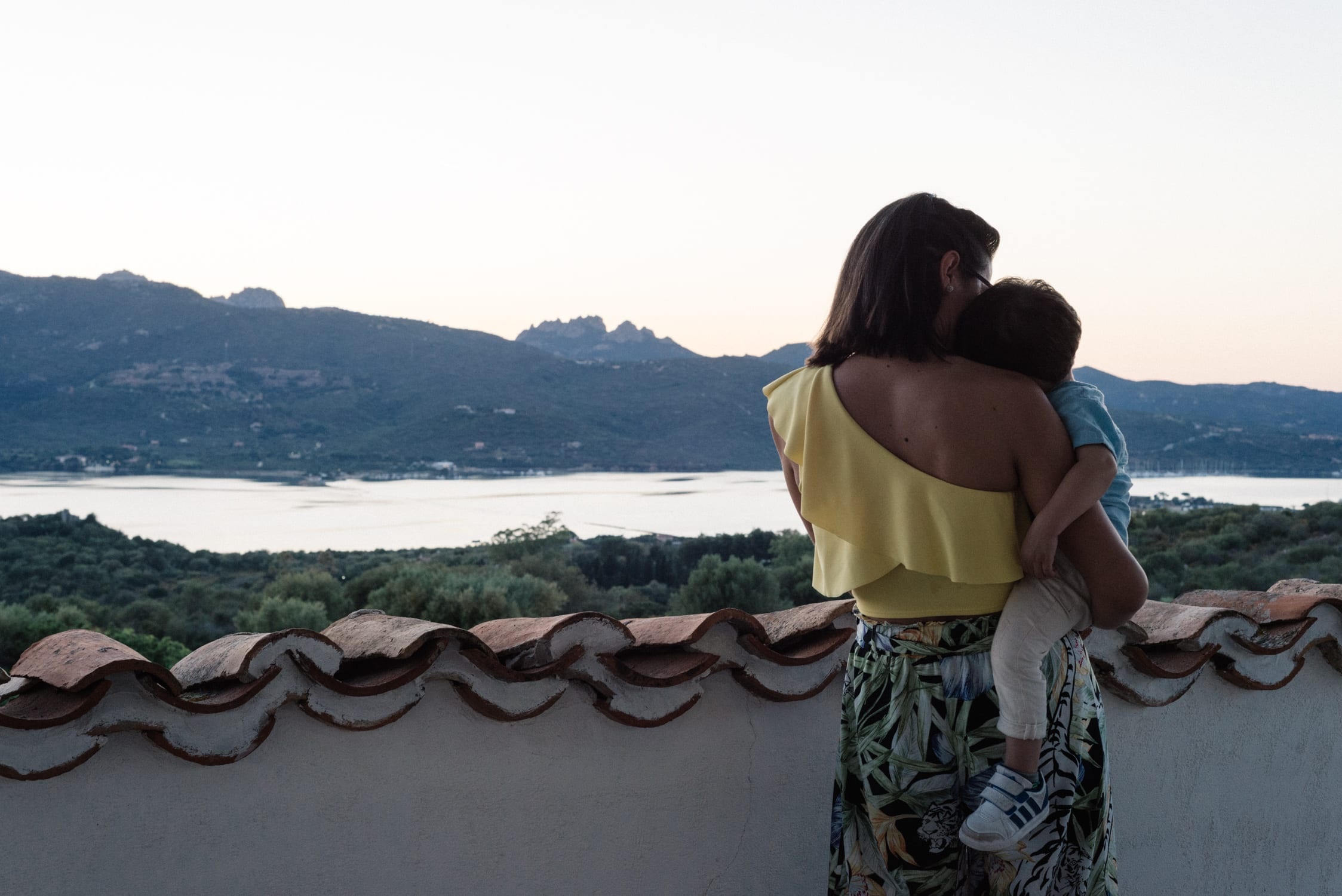 Holding a child close, the water below, Kaleidos Wedding