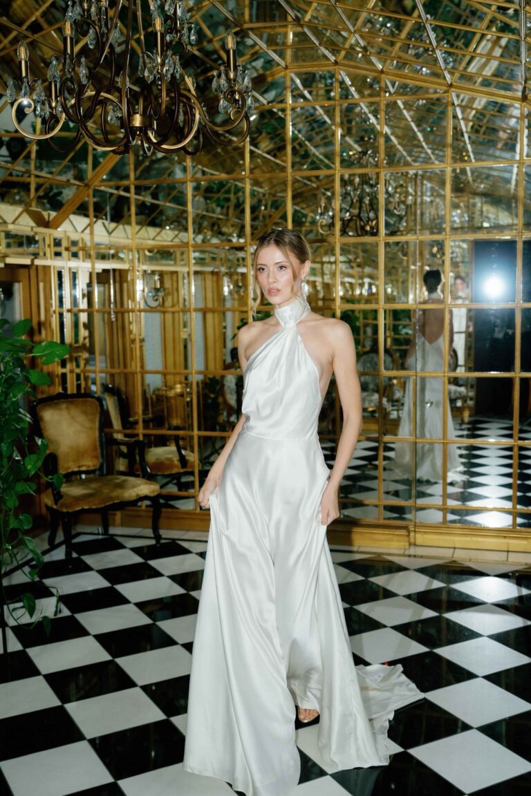 A halter neck bias cut gown on a chequerboard floor, Kate Edmondson Bridal Couture