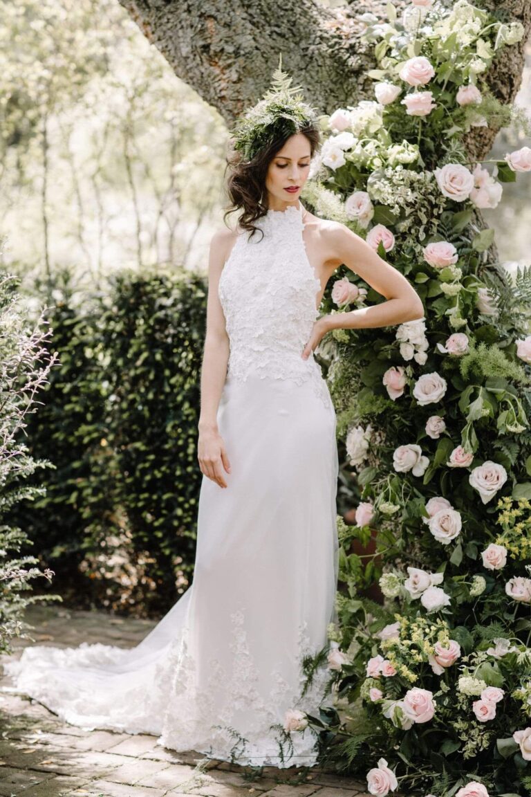 A halter neck gown beside an arch of climbing roses, Kate Edmondson Bridal Couture