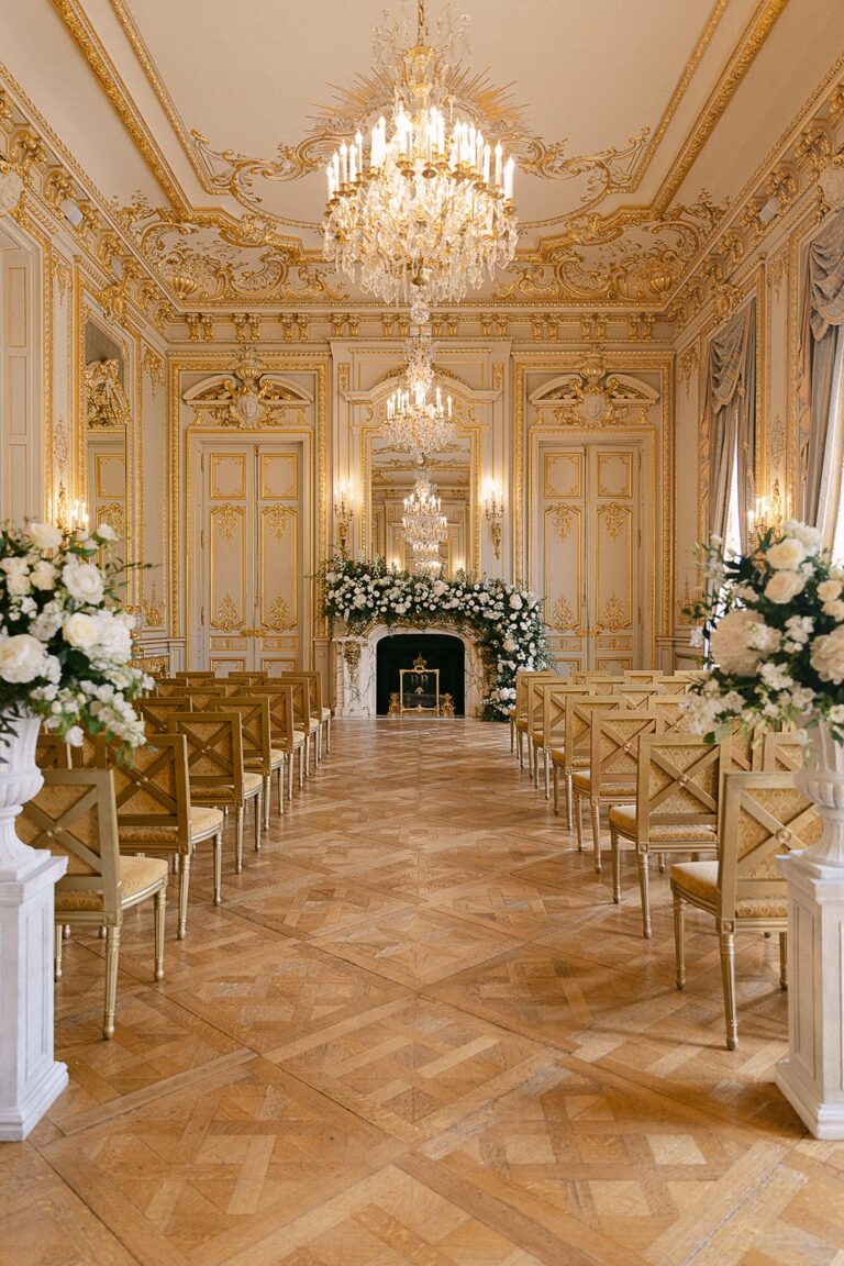 Gilded salon set for a ceremony with gold chairs and white floral arrangements, Katerina Meyvial Wedding & Event Planner