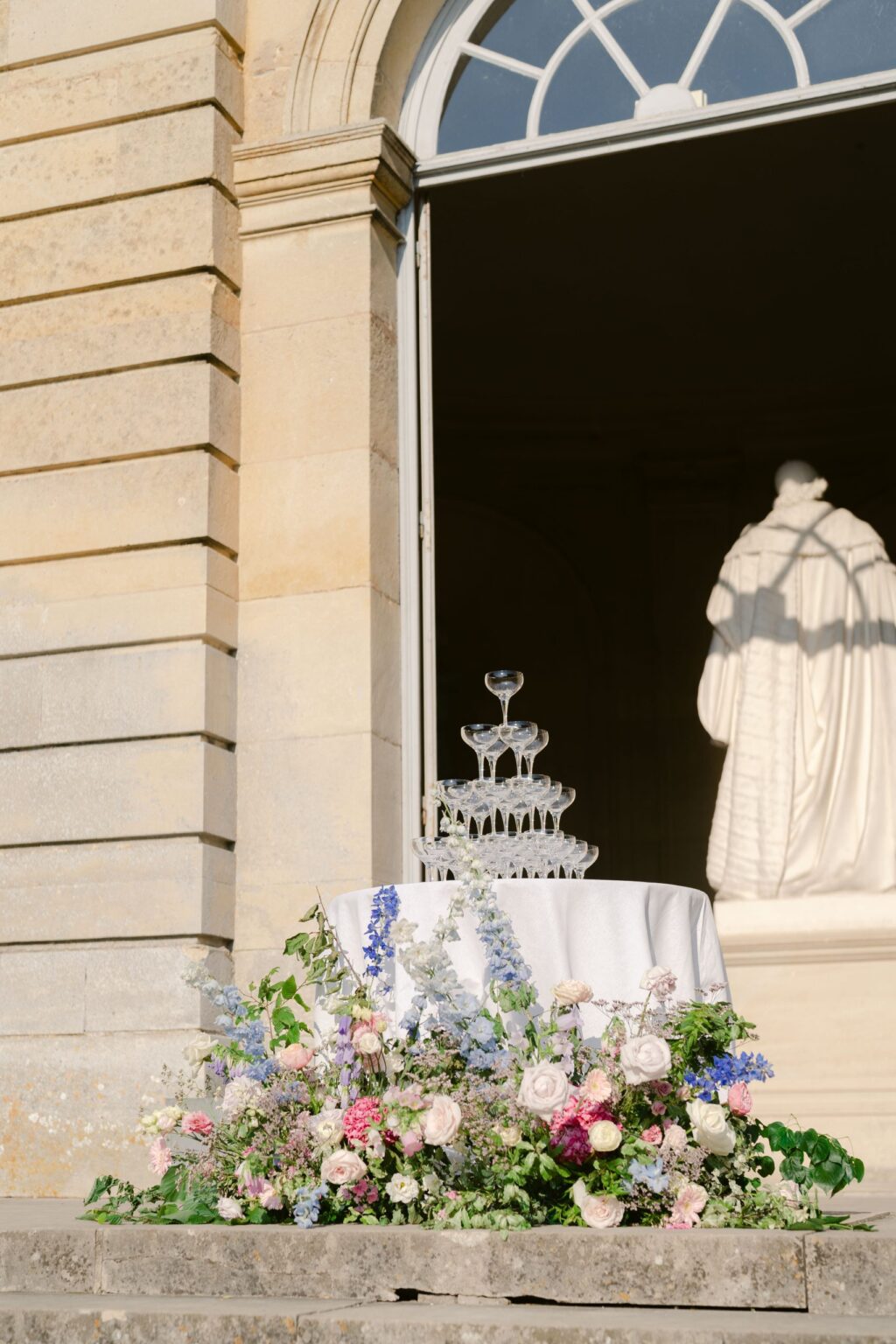 Champagne tower on the terrace with a spring floral arrangement, Katerina Meyvial Wedding & Event Planner