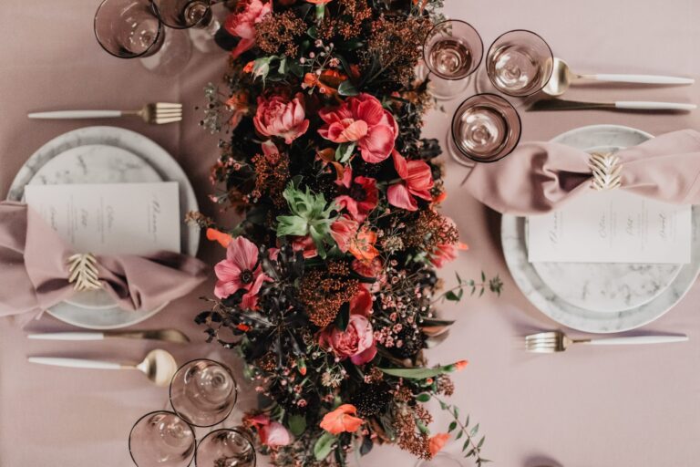 Overhead view of a table set with red roses, glasses and place cards, Katerina Meyvial Wedding & Event Planner