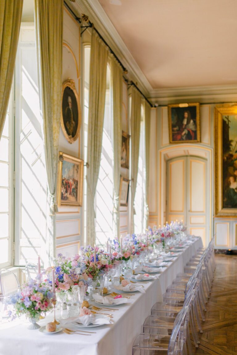Long table with low flowers in a salon at Château de Champlatreux, Katerina Meyvial Wedding & Event Planner