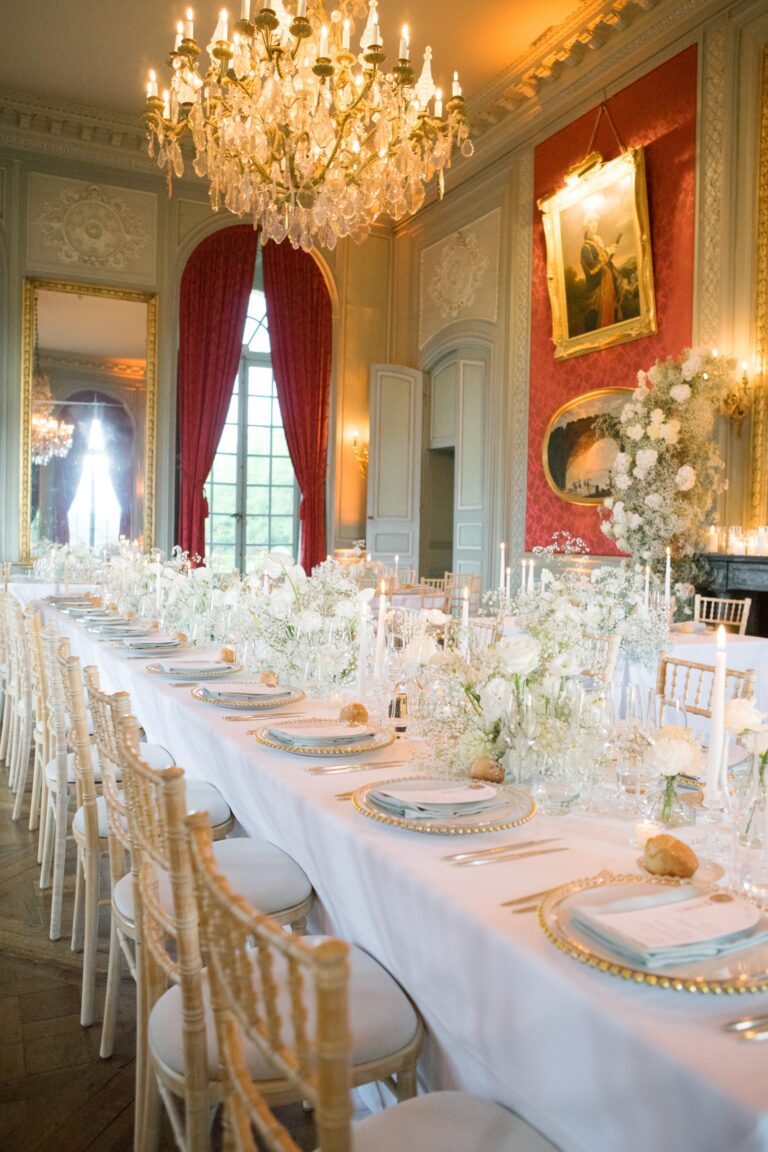 Candlelit long table with white flowers in a red and gold salon, Katerina Meyvial Wedding & Event Planner