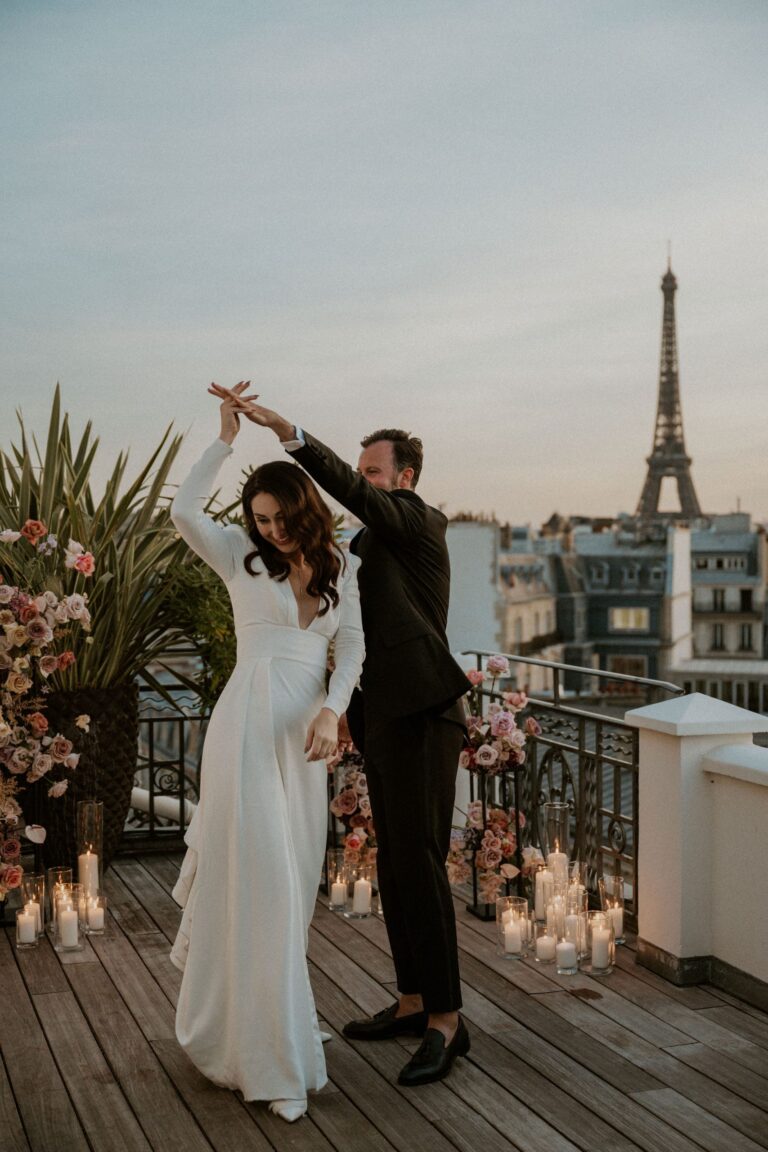 Couple dancing on a Paris rooftop at dusk with the Eiffel Tower behind, Katerina Meyvial Wedding & Event Planner