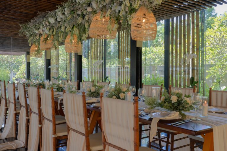 Long dining table set under floral installations, Kayumanis Nusa Dua Private Villa and Spa