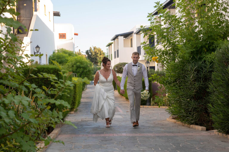 Couple walking through the resort village, Kefalos Beach Weddings