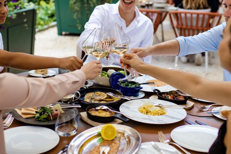 Dishes shared at a table in Cattani Restaurant, Kempinski Palace Engelberg