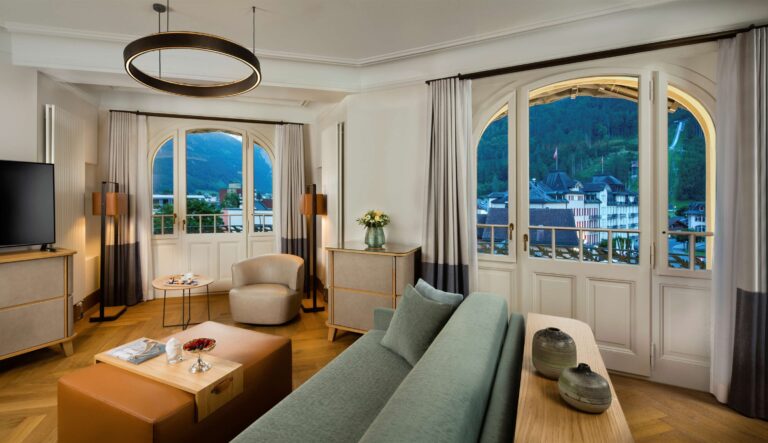 A suite living area with arched windows, Kempinski Palace Engelberg